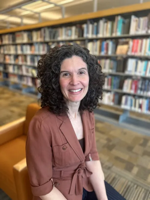 Annie Schmidt poses among the stacks at Minneapolis Central Library.