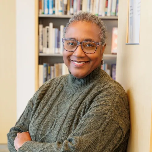 Portrait of Gale Cannon in front of the stacks at Minneapolis Central Library