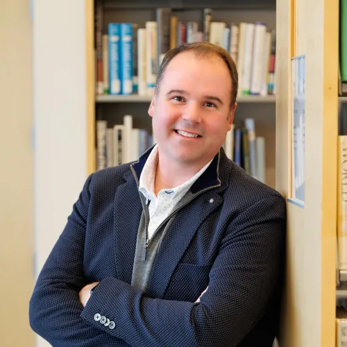 Rob Goudy poses among the stacks at Minneapolis Central Library.