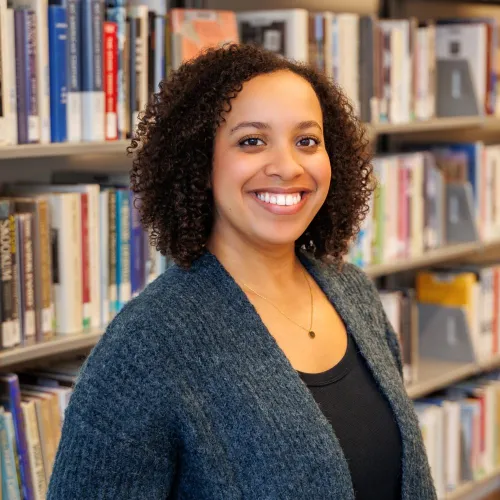 Semira Mesfin in front of stacks at Minneapolis Central Library