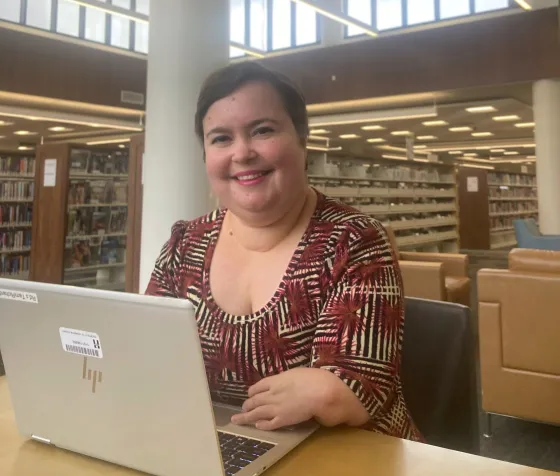 Senior Librarian Tami poses on her laptop at Ridgedale Library.