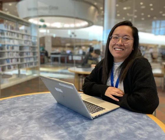 Lead Tutor Melody poses with her laptop at Brookdale Library.